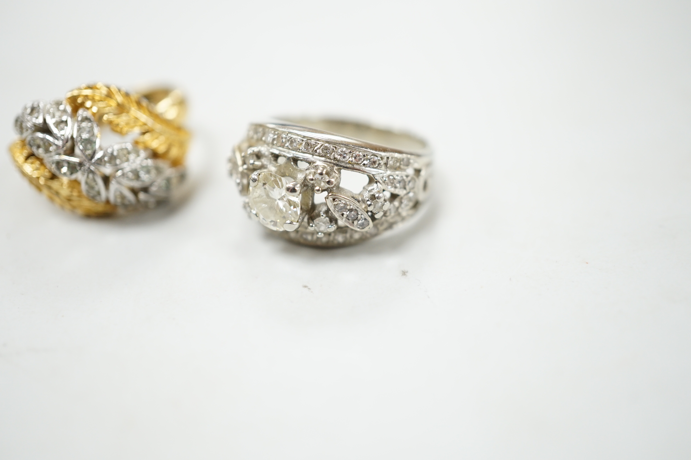 A mid 20th century white metal and single stone diamond set dress ring with diamond chip setting, size L, gross weight 6.1 grams and a costume ring.